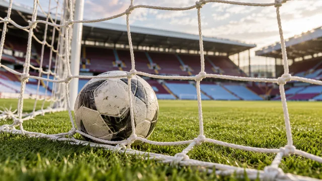 AI-generated illustration of a football in a goal net with claret and blue stadium seating behind.