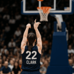 Caitlin Clark taking a jump shot during a WNBA game, highlighting the debate over WNBA pay and player value.