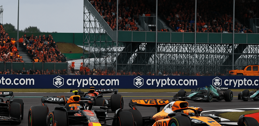 F1 Silverstone 2026 sprint race action with McLaren and Red Bull cars battling on track in front of packed grandstands.
